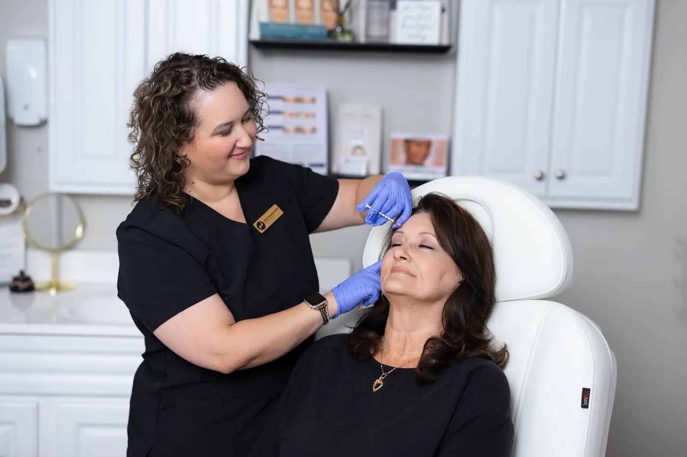 Back to 30 practitioner providing an aesthetic treatment